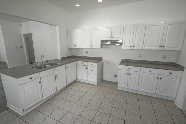 425 Park Blvd, New Orleans, LA 70114 - kitchen with a peninsula, white cabinetry, under cabinet range hood, light tile patterned floors, and recessed lighting