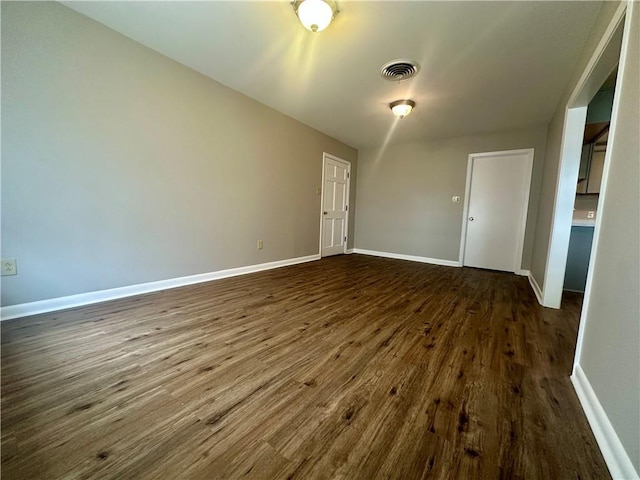 8732 25th St, Metairie, LA 70003 - spare room featuring dark wood finished floors and baseboards