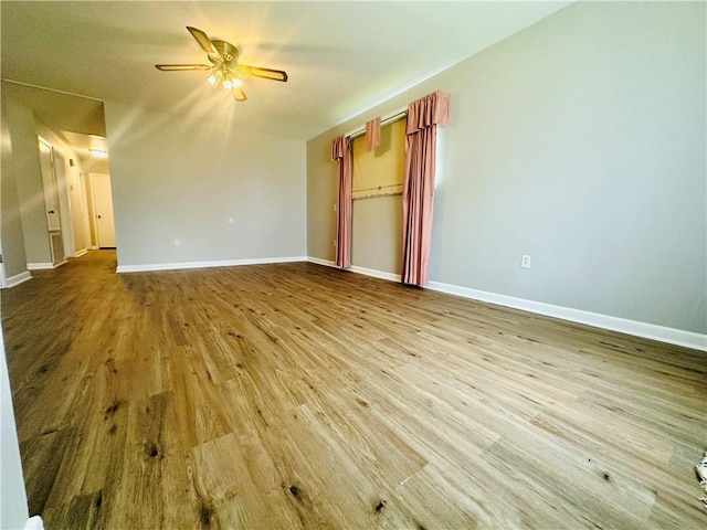 8732 25th St, Metairie, LA 70003 - unfurnished bedroom featuring wood finished floors, a ceiling fan, and a spacious closet
