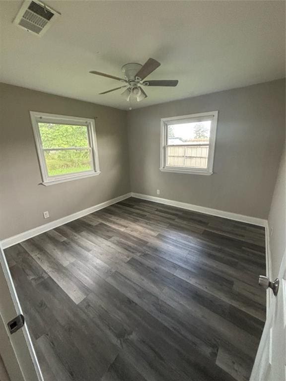 1905 Farmington Pl, Gretna, LA 70056 - empty room with healthy amount of natural light, ceiling fan, and dark wood-style floors
