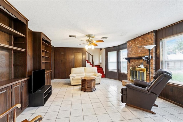 3125 Metairie Ct, Metairie, LA 70002 - living area with wood walls, plenty of natural light, a textured ceiling, stairway, and light tile patterned flooring