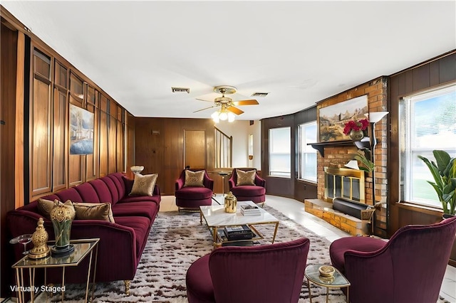 3125 Metairie Ct, Metairie, LA 70002 - living area featuring plenty of natural light, wooden walls, a ceiling fan, and a fireplace