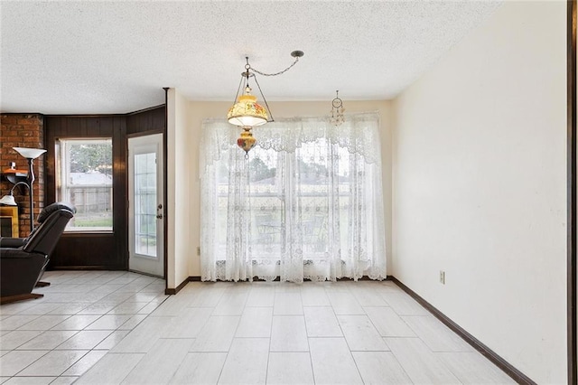 3125 Metairie Ct, Metairie, LA 70002 - unfurnished dining area with a textured ceiling and light tile patterned floors