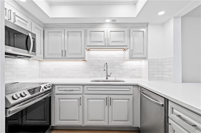 300 Lake Marina Ave Unit 7-C, New Orleans, LA 70124 - kitchen featuring stainless steel appliances, light countertops, decorative backsplash, recessed lighting, and a raised ceiling