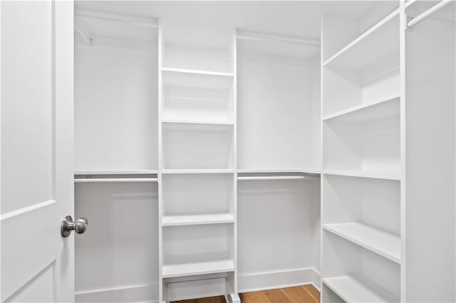 300 Lake Marina Ave Unit 7-C, New Orleans, LA 70124 - walk in closet featuring wood finished floors