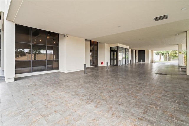 300 Lake Marina Ave Unit 7-C, New Orleans, LA 70124 - unfurnished living room with a wall of windows
