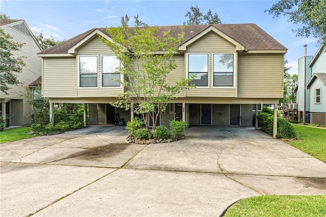 26 Chamale Cv Unit 26, Slidell, LA 70460 - view of front of house with a carport, concrete driveway, and roof with shingles