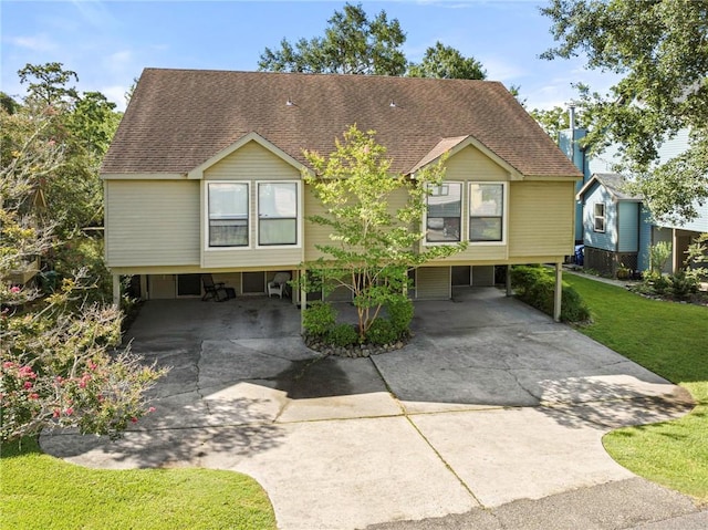 26 Chamale Cv Unit 26, Slidell, LA 70460 - view of front of home featuring a carport, driveway, a shingled roof, and a front lawn