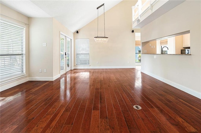 26 Chamale Cv Unit 26, Slidell, LA 70460 - unfurnished living room with healthy amount of natural light, dark wood finished floors, and high vaulted ceiling