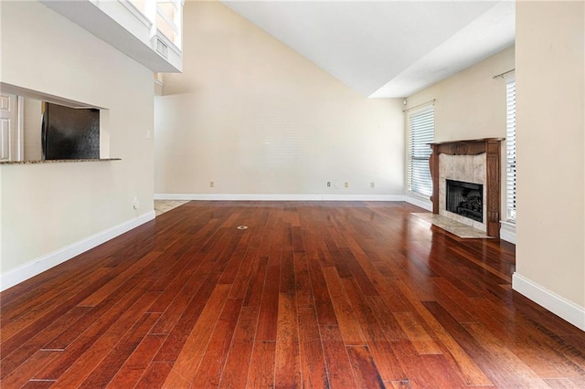 26 Chamale Cv Unit 26, Slidell, LA 70460 - unfurnished living room featuring a premium fireplace, wood finished floors, and high vaulted ceiling