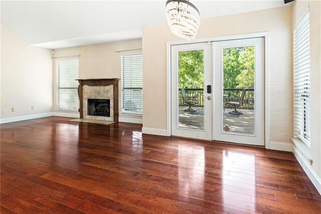 26 Chamale Cv Unit 26, Slidell, LA 70460 - unfurnished living room featuring plenty of natural light, a chandelier, wood finished floors, and a high end fireplace