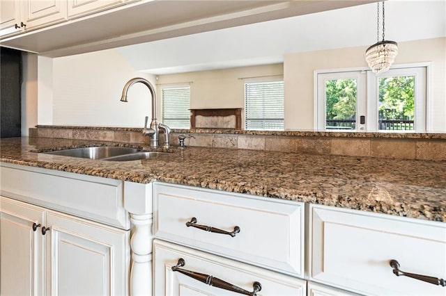 26 Chamale Cv Unit 26, Slidell, LA 70460 - kitchen with dark stone countertops, white cabinets, and pendant lighting