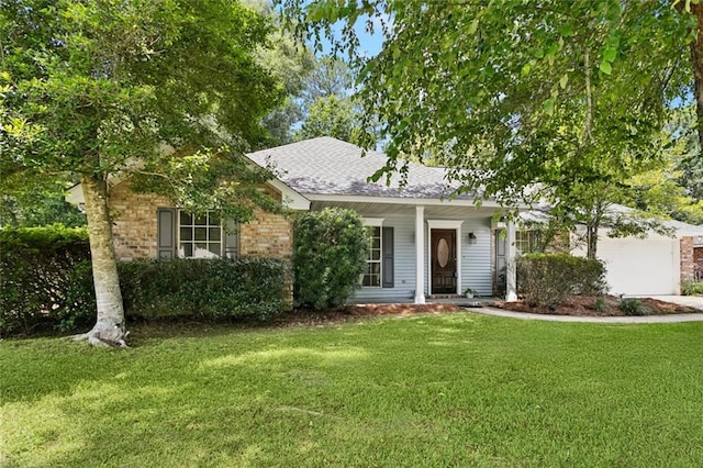 418 Westwood Dr, Mandeville, LA 70471 - view of front of property featuring a front yard, an attached garage, a shingled roof, concrete driveway, and brick siding