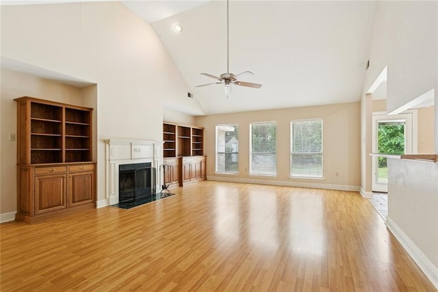 418 Westwood Dr, Mandeville, LA 70471 - unfurnished living room with ceiling fan, light wood-type flooring, a fireplace, and high vaulted ceiling