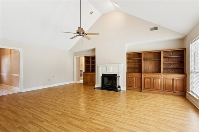 418 Westwood Dr, Mandeville, LA 70471 - unfurnished living room with light wood-type flooring, a ceiling fan, high vaulted ceiling, and a fireplace with flush hearth