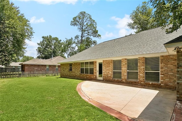 418 Westwood Dr, Mandeville, LA 70471 - rear view of house featuring a shingled roof, brick siding, and a patio