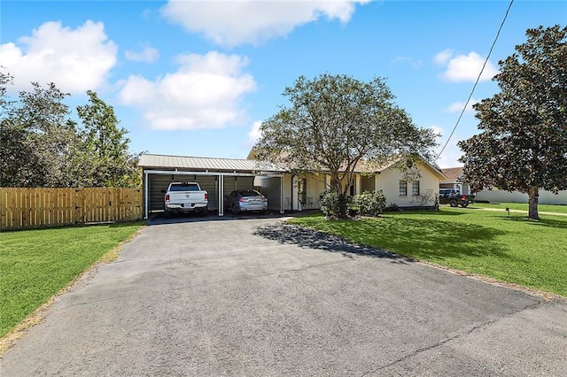 1929 Jean Lafitte Blvd, Lafitte, LA 70067 - ranch-style house featuring asphalt driveway, a detached carport, and a metal roof