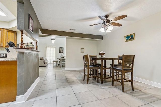 1929 Jean Lafitte Blvd, Lafitte, LA 70067 - dining room with a ceiling fan, light tile patterned flooring, and a textured ceiling