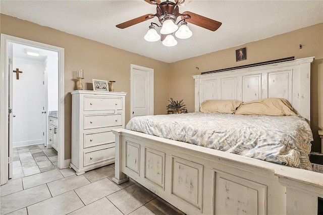 1929 Jean Lafitte Blvd, Lafitte, LA 70067 - bedroom with ceiling fan, light tile patterned floors, and ensuite bath