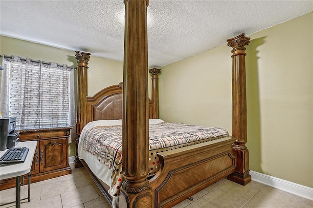 1929 Jean Lafitte Blvd, Lafitte, LA 70067 - bedroom with a textured ceiling, light tile patterned floors, and decorative columns