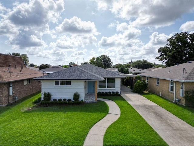 861 W William David Pkwy, Metairie, LA 70005 - view of front of property with concrete driveway, a front yard, a shingled roof, and a carport
