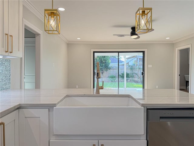 861 W William David Pkwy, Metairie, LA 70005 - kitchen with stainless steel dishwasher, light stone counters, ornamental molding, recessed lighting, and white cabinets