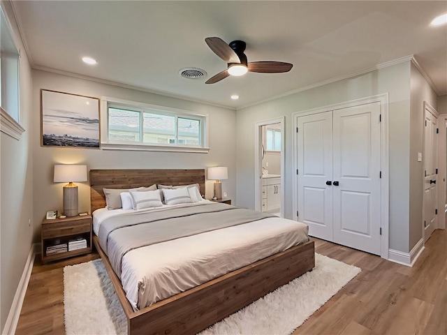 861 W William David Pkwy, Metairie, LA 70005 - bedroom featuring crown molding, light wood-style floors, a closet, ensuite bathroom, and ceiling fan