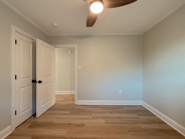861 W William David Pkwy, Metairie, LA 70005 - unfurnished bedroom with light wood-style flooring, crown molding, ceiling fan, and a closet
