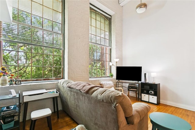 920 Poeyfarre St Unit 326, New Orleans, LA 70130 - living room featuring wood-type flooring and healthy amount of natural light