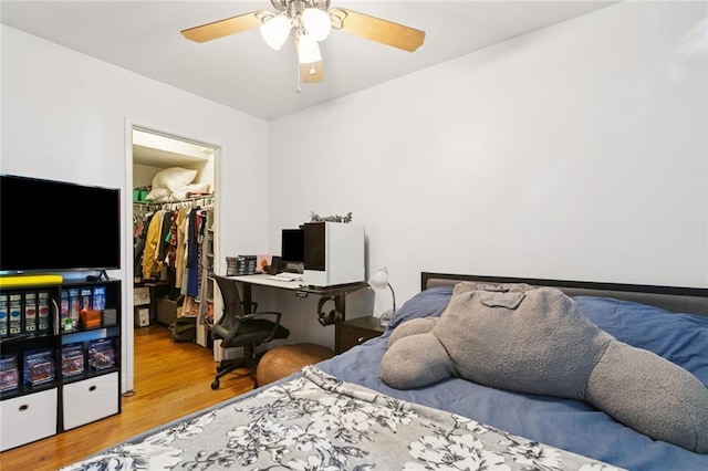 920 Poeyfarre St Unit 326, New Orleans, LA 70130 - bedroom featuring a walk in closet, wood finished floors, and a ceiling fan