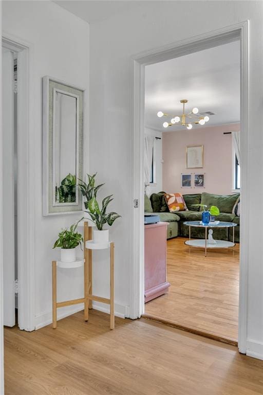 4430 Karen Ave, Jefferson, LA 70121 - corridor featuring light wood finished floors and a chandelier