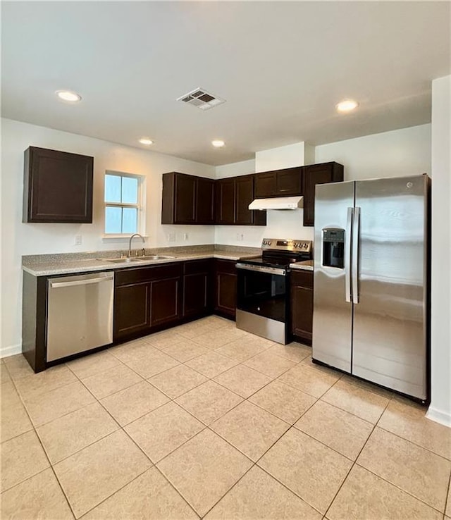 70330 C St, Covington, LA 70433 - kitchen featuring stainless steel appliances, under cabinet range hood, dark brown cabinetry, light countertops, and light tile patterned flooring