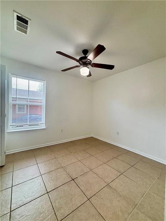 70330 C St, Covington, LA 70433 - empty room with light tile patterned floors and a ceiling fan