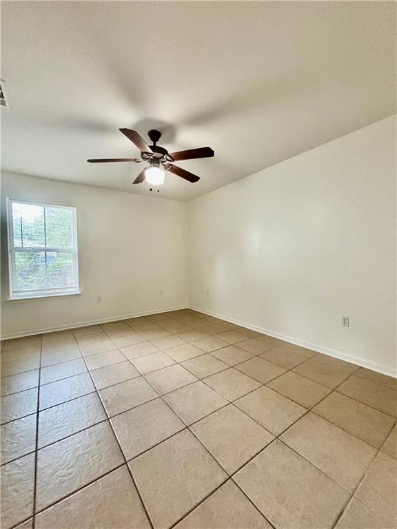 70330 C St, Covington, LA 70433 - spare room with light tile patterned floors and ceiling fan