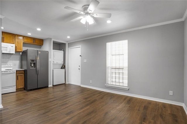 4218 Hessmer Ave Unit 217, Metairie, LA 70002 - kitchen featuring white appliances, stacked washer / dryer, ceiling fan, crown molding, and dark wood-type flooring