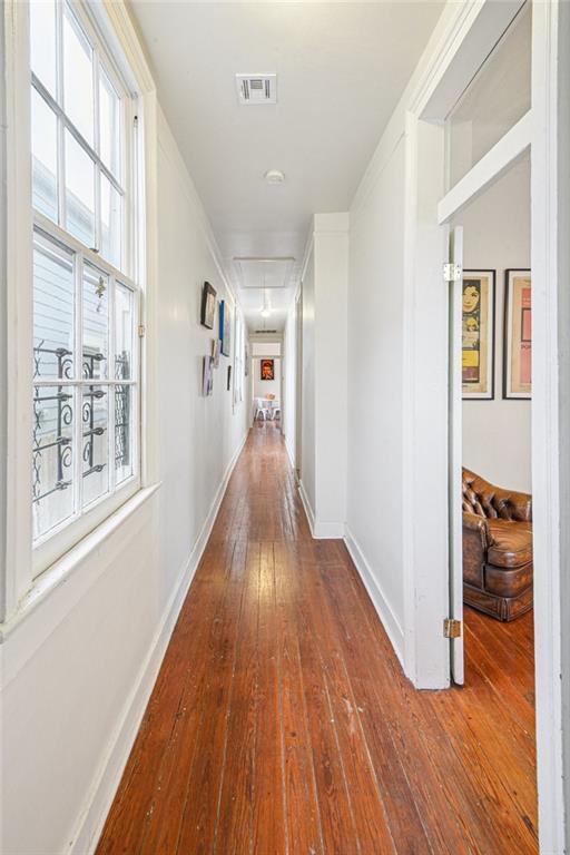 1821 Urquhart St, New Orleans, LA 70116 - hallway featuring attic access and hardwood / wood-style flooring