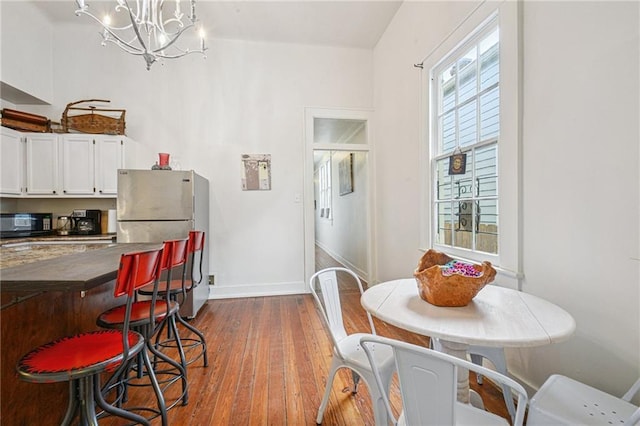 1821 Urquhart St, New Orleans, LA 70116 - dining room with a chandelier and dark wood-style floors