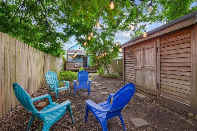 1821 Urquhart St, New Orleans, LA 70116 - fenced backyard featuring a wooden deck and an outdoor structure