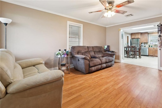 212 7th St, Bridge City, LA 70094 - living area with light wood-style flooring, ceiling fan, and ornamental molding