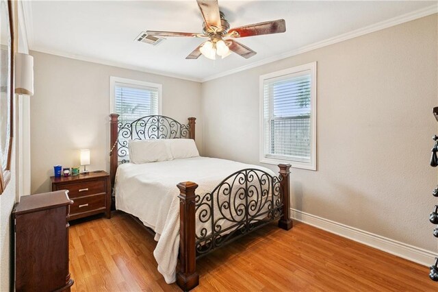 212 7th St, Bridge City, LA 70094 - bedroom with light wood-style flooring, crown molding, and a ceiling fan