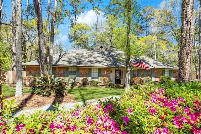 124 N Dr, Covington, LA 70433 - view of front of home with brick siding and a chimney