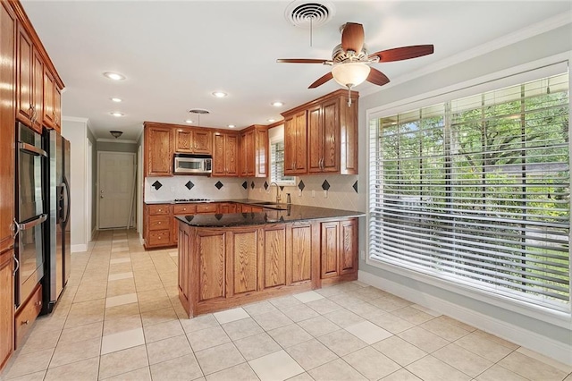 124 N Dr, Covington, LA 70433 - kitchen with appliances with stainless steel finishes, a peninsula, ornamental molding, tasteful backsplash, and ceiling fan