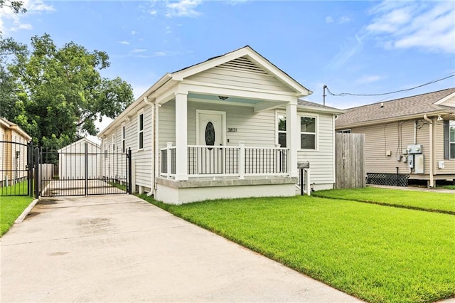 3821 Bauvais St, Metairie, LA 70001 - shotgun-style home with a porch, a gate, and concrete driveway