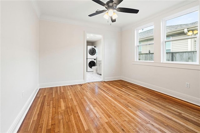 3821 Bauvais St, Metairie, LA 70001 - unfurnished room with stacked washer / drying machine, light wood-type flooring, ornamental molding, and a ceiling fan