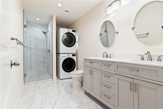 3821 Bauvais St, Metairie, LA 70001 - full bathroom with estacked washer and dryer, marble look tiles, a shower stall, double vanity, and recessed lighting