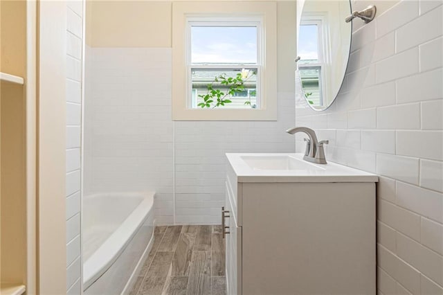 3821 Bauvais St, Metairie, LA 70001 - full bathroom featuring tile walls, vanity, and wood finished floors
