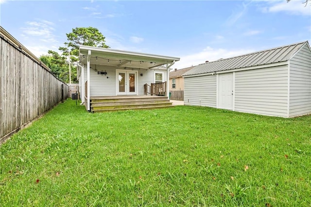 3821 Bauvais St, Metairie, LA 70001 - back of house featuring french doors, a fenced backyard, a deck, and an outdoor structure