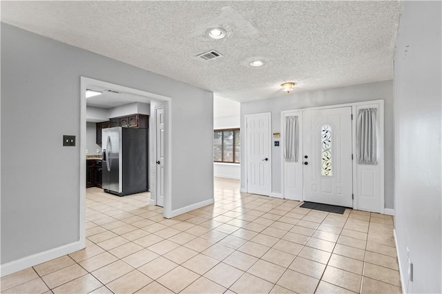 1701 Cambridge Dr, La Place, LA 70068 - entrance foyer with a textured ceiling and light tile patterned flooring