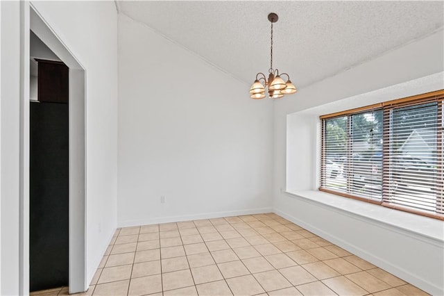 1701 Cambridge Dr, La Place, LA 70068 - empty room with a chandelier, a textured ceiling, lofted ceiling, and light tile patterned flooring