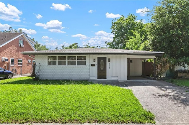 513 Roseland Pkwy, Harahan, LA 70123 - view of front of property with a front lawn, brick siding, a carport, and asphalt driveway
